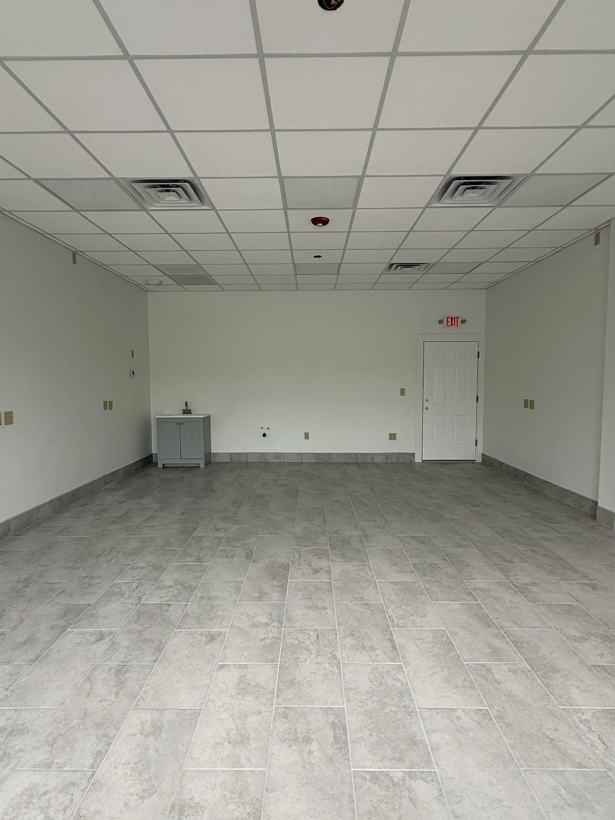 Unit 2 from the storefront looking toward the rear wall and the door to the rear hallway