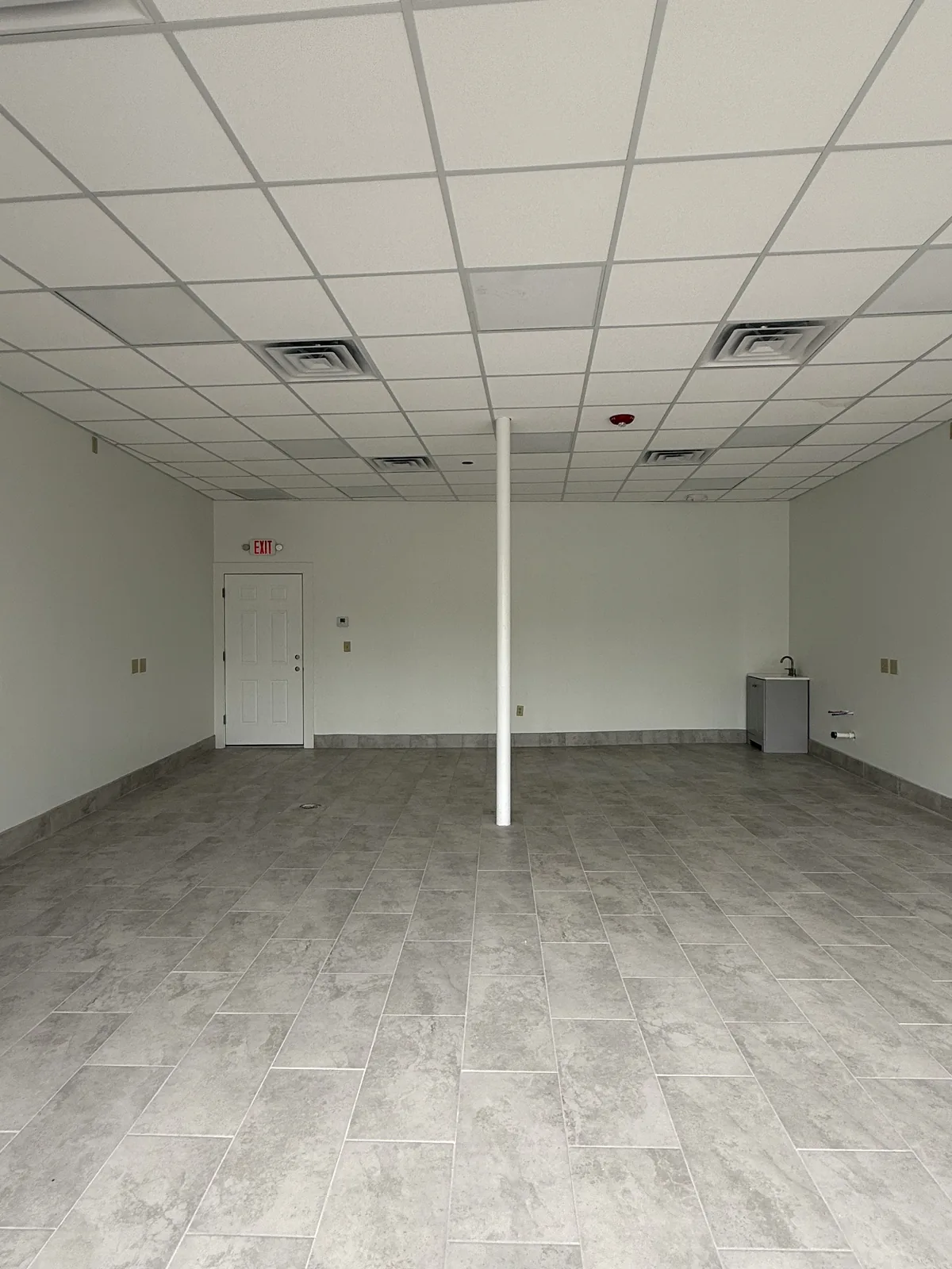 Unit 3 from the storefront looking past the support post toward the rear door