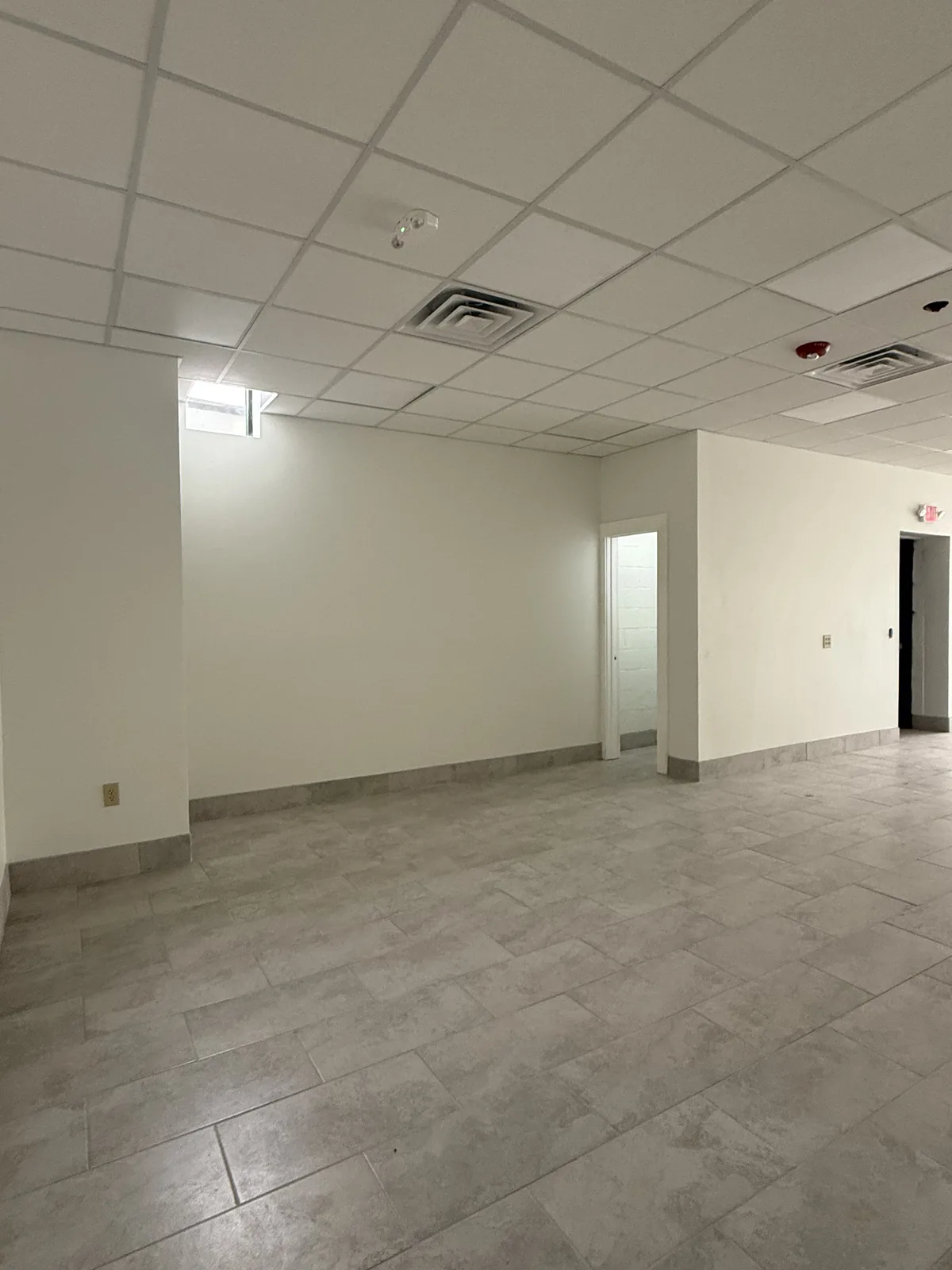Rear area of Unit 4 with a high window and doorways